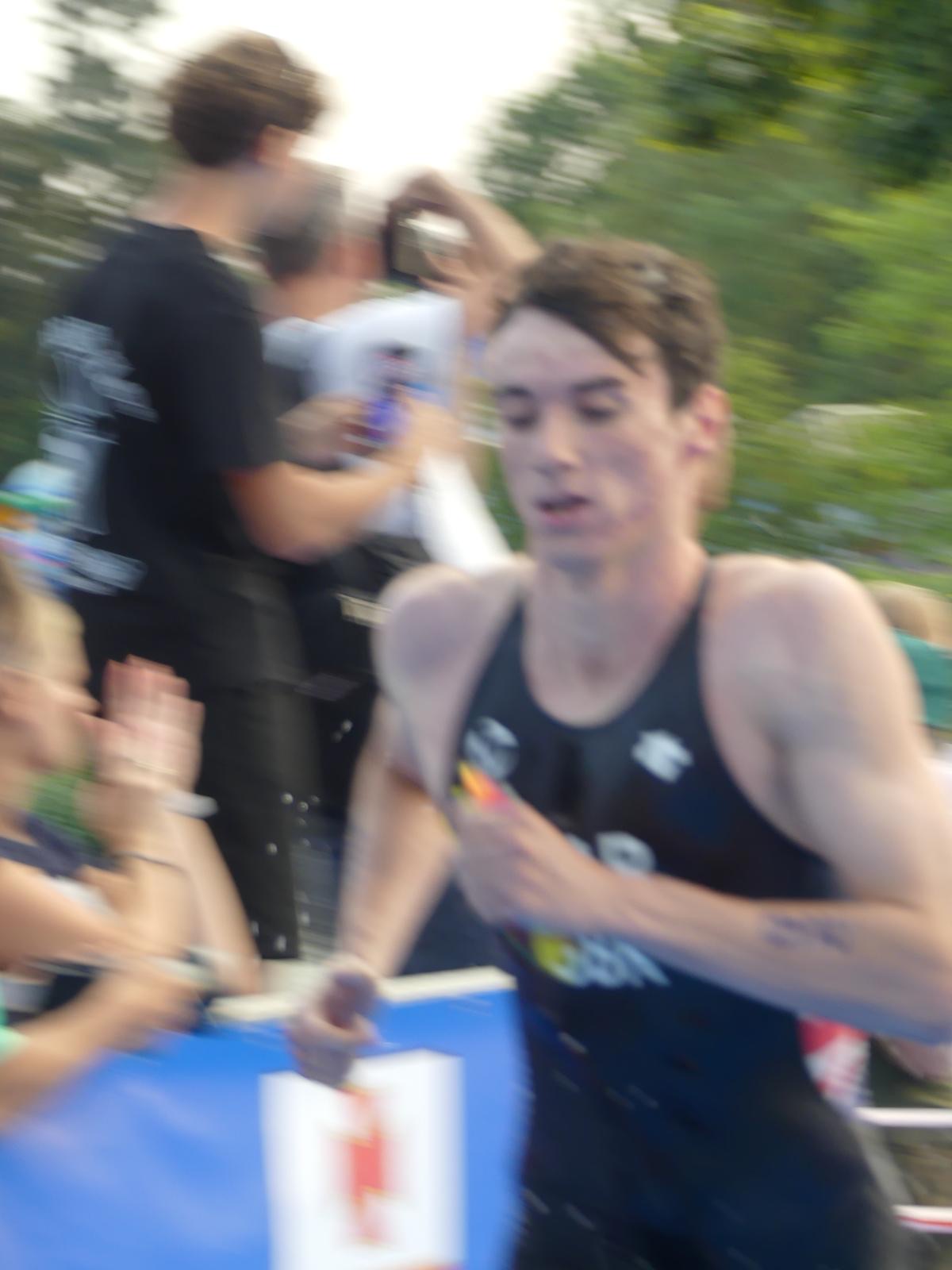 Michael Gar running through an aid station in GB kit