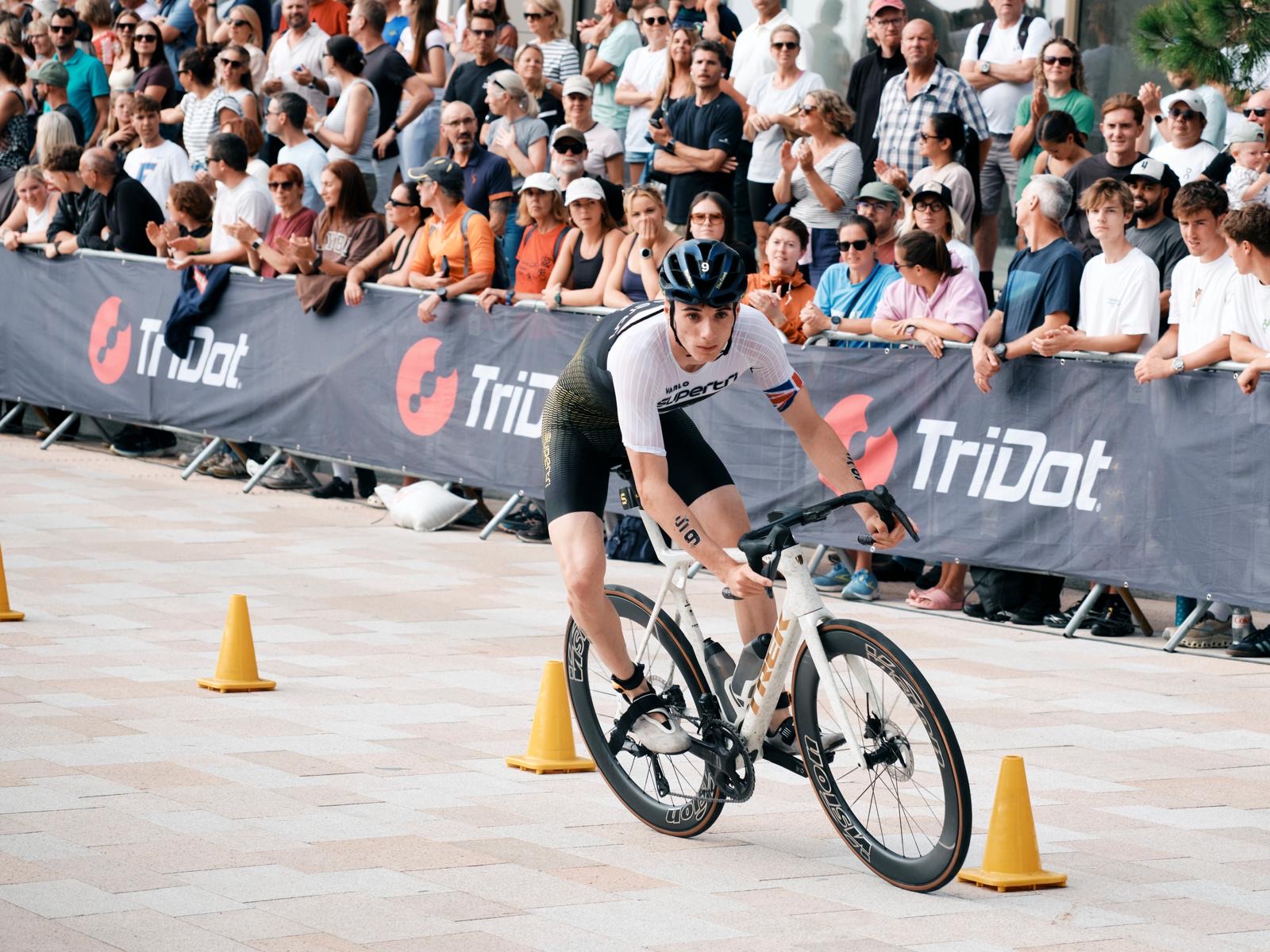 Michael Gar riding past the crowd on the bike leg at supertri Jersey